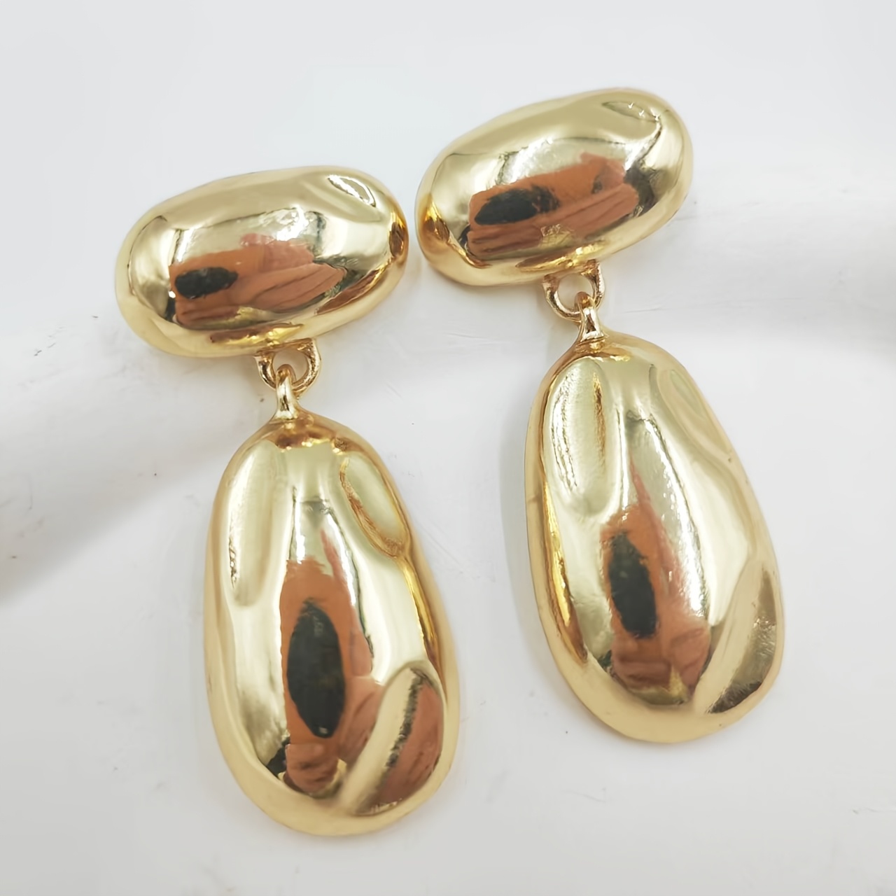 Metal Earrings with Golden Glossy Finish and Teardrop Pendant